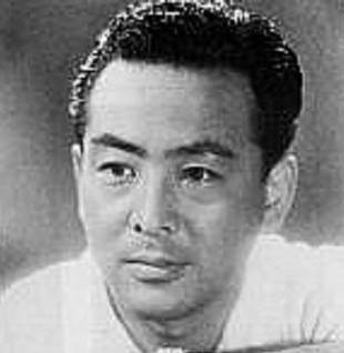 Head shot of a Japanese male actor wearing a casual shirt and looking slightly to one side of the camera
