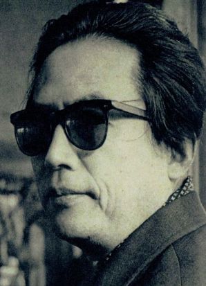 Profile close-up shot of a Japanese man in modern clothing wearing sunglasses