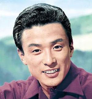 Photo of a 1950s Japanese man smiling, looking at the camera