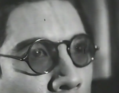Extreme close-up of Tetsuo with sunglasses, looking horrified