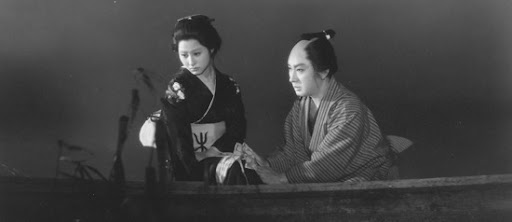 A Japanese man and a woman sitting in a boat, both looking off to the side, rather than at each other