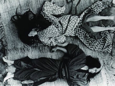 A Japanese man and woman, in traditional garb, lie dead on the ground, facing in different directions