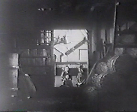 In the doorway of a barn is seen a woman and two children, with the man, Kanji, bowing before them