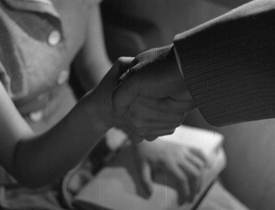 A close-up of two people, a man and woman, shaking hands