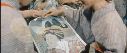 Some girls in a factory in feudal Japan gather round to admire drawings of women depicted by Ukiyo-e painters