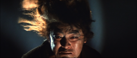 Stylized photo of a Japanese man with flames behind him, made up to resemble a demon