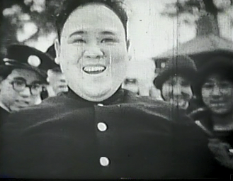 The same Japanese bus driver still in uniform, with a crowd of people behind him, but now broadly smiling