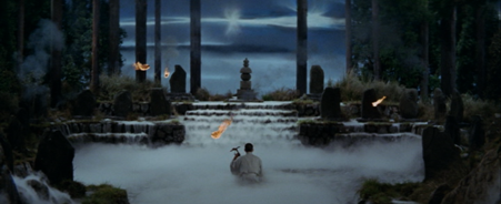 A young man in the middle distance with a biwa sits before a gate, while tongues of flame from an invisible source dance around him