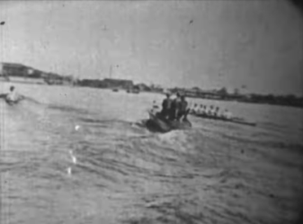 Photograph of a river showing boats in a boat race in the near distance