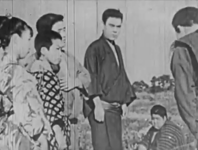 A group of Japanese in traditional dress (three adults and three children) in some kind of confrontation, in which the young adult stares at another, who bows to him