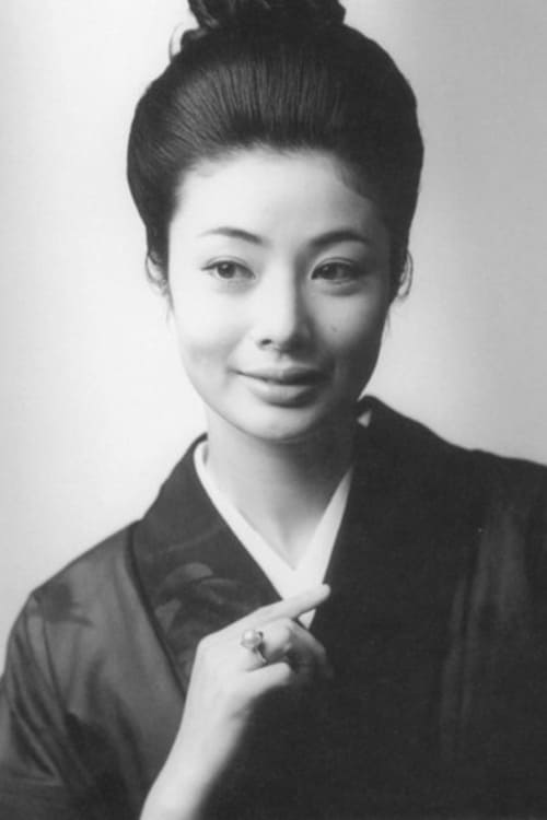 Photo of a young Japanese woman in her 20s, in traditional kimono and wearing upswept hair.