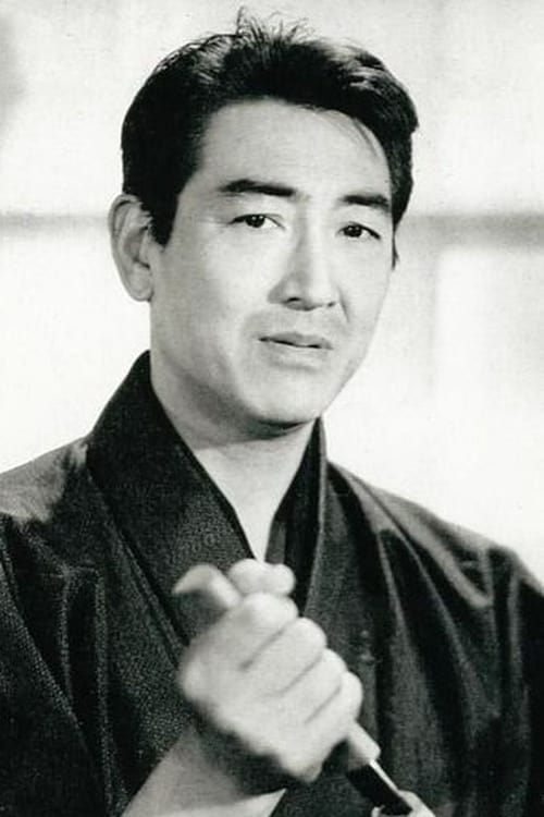 Photo of a Japanese man in his late 30s, in traditional Japanese kimono, looking at the camera and holding a knife in his hand.