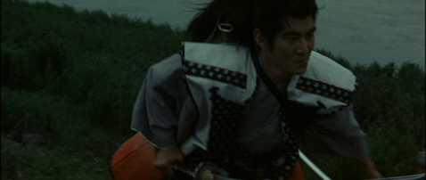 In the countryside, the samurai with shoulder-length hair charges with his sword drawn toward an enemy