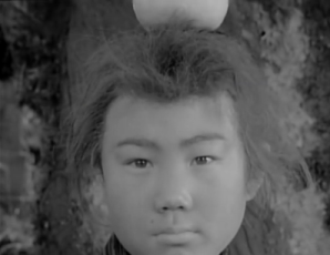 A Japanese boy from the feudal era, standing with his back to a tree, starting directly towards the camera, with a piece of fruit on top of his head