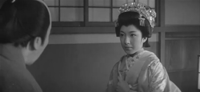 A young Japanese woman in upper-class feudal dress stares at an older man, who has his back to the camera on the left side of the frame